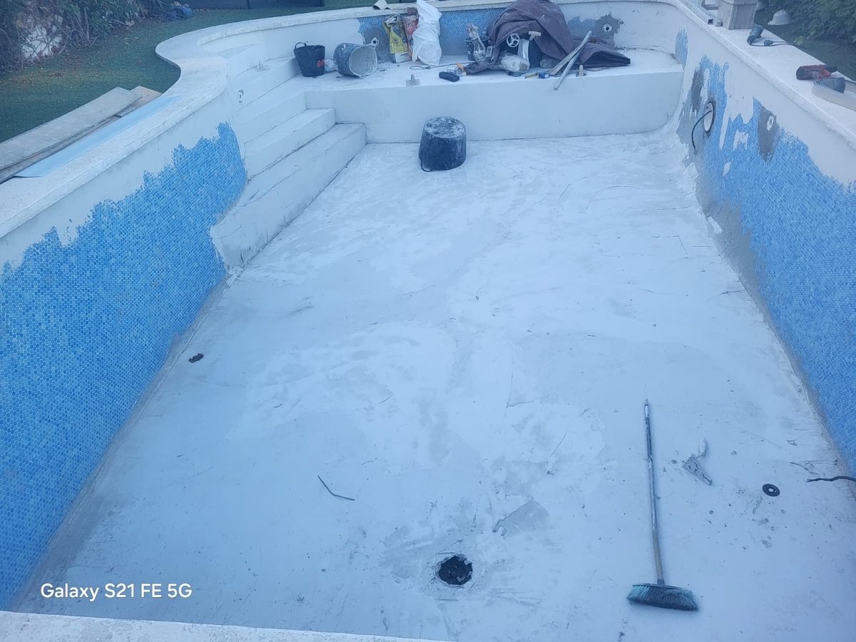 Empty boat deck covered in white material with blue side panels and mounted equipment